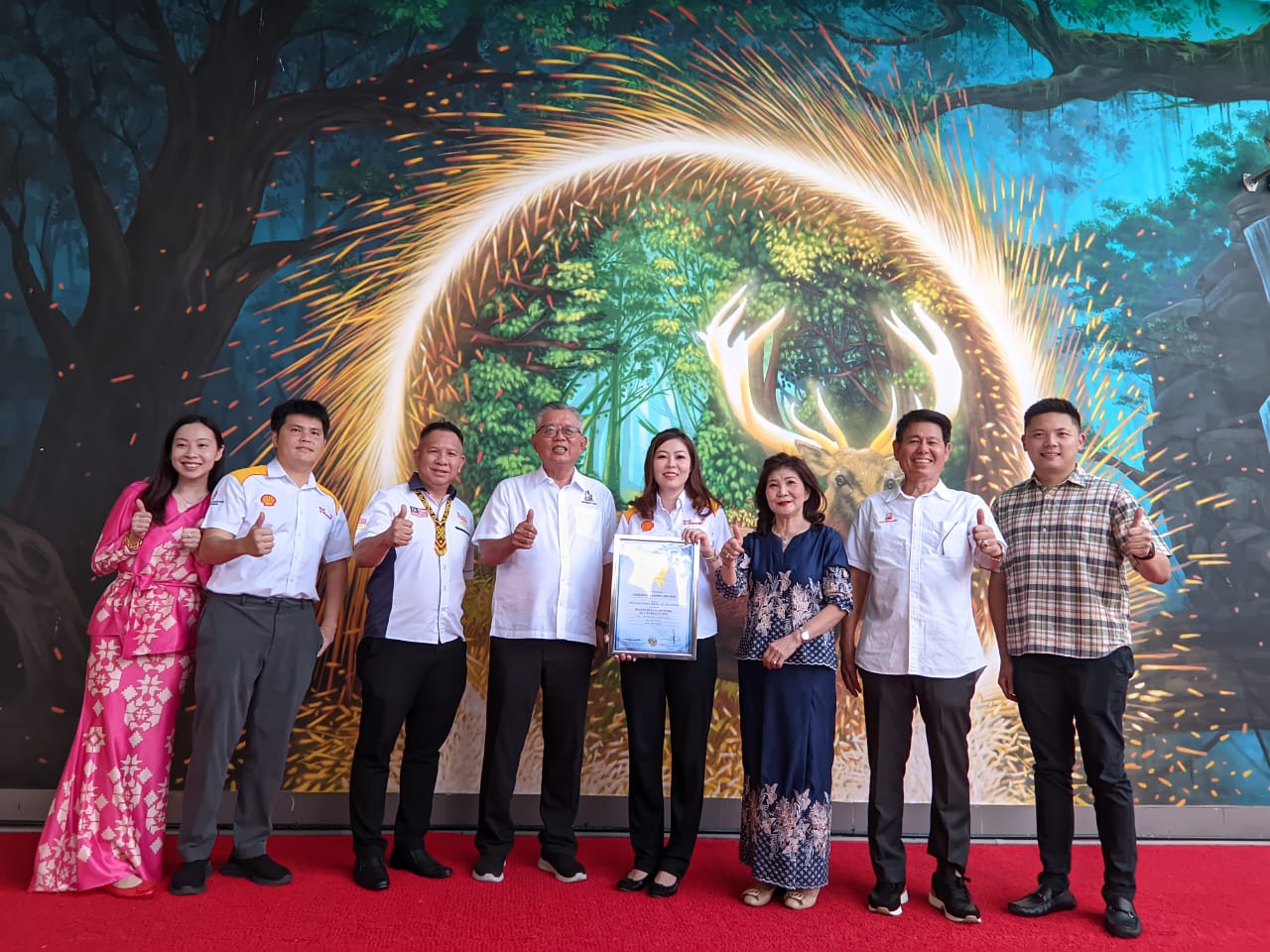 (from left) Pricilla, Johnson, Yeoh, Ting, Amelia, Siew, Tiu and Joshua take one for the album with the mural. – Photo by Peter Boon