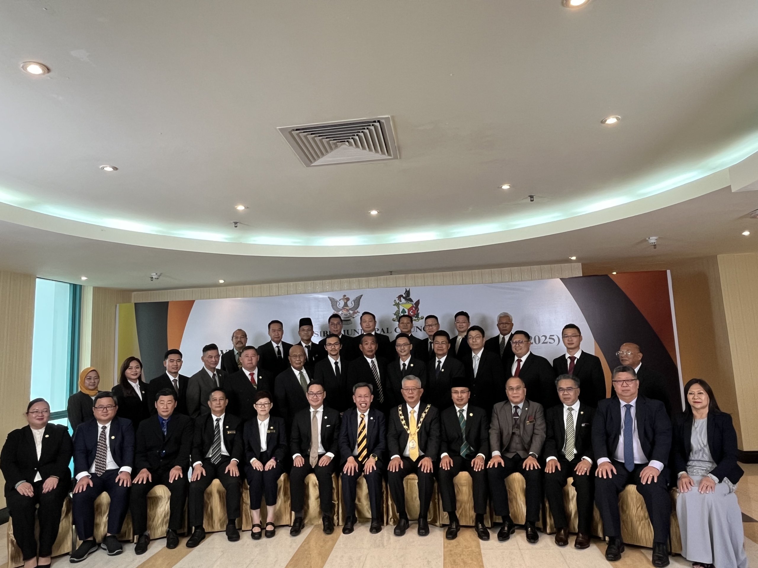 Dr Sim (seated, centre) takes one for the album with reappointed chairman Clarence Ting (sixth right), Law (second left, second row), Raden (third left, second row) and other councillors.