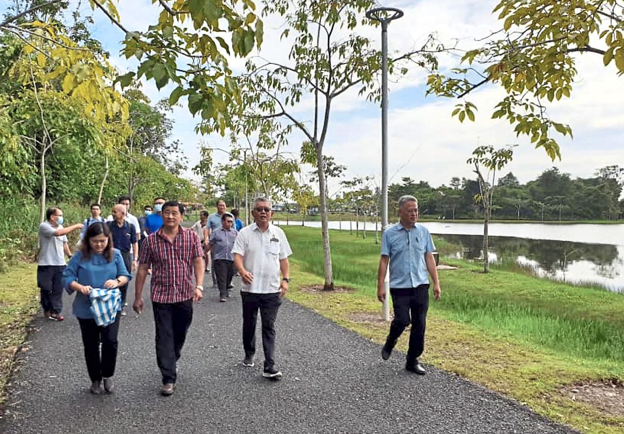 Ting (second from right) with Tiong (second from left) inspecting the site for the cycling track.