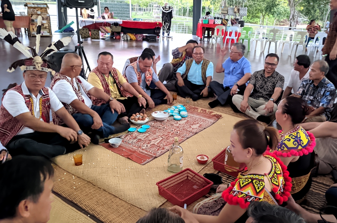 Stanley (third left), Augustine (left), (from eighth left) Ting, Izkandar and others during a ‘miring’ ceremony before the launching of Gawai Dayak Bazaar Sibu 2023. – Photo by Peter Boon