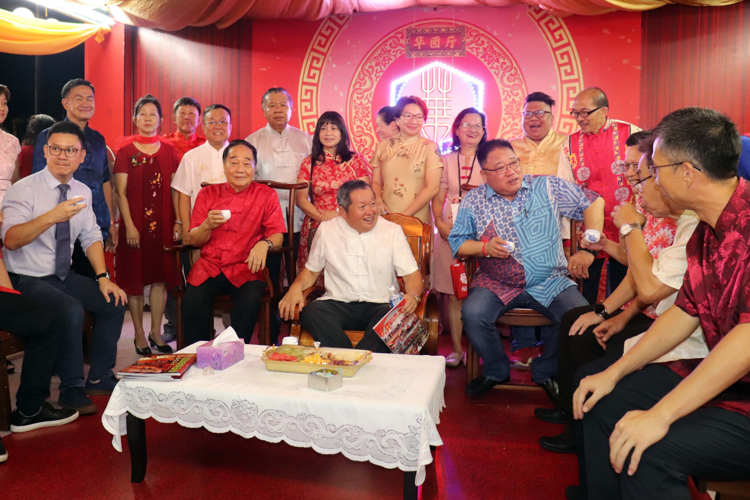 Tiong (seated fourth left) has tea at the Chinese pavilion. Seated from left are Ling, Wong, Ing Siong, and Chieng. — Photo by Conny Banji