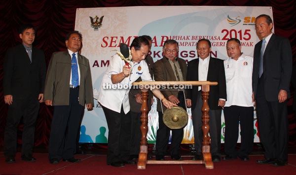 Wong (left) hits the gong while (from left) Hii, James Laju, John Sikie, Peter, Chan and Tiong look on.