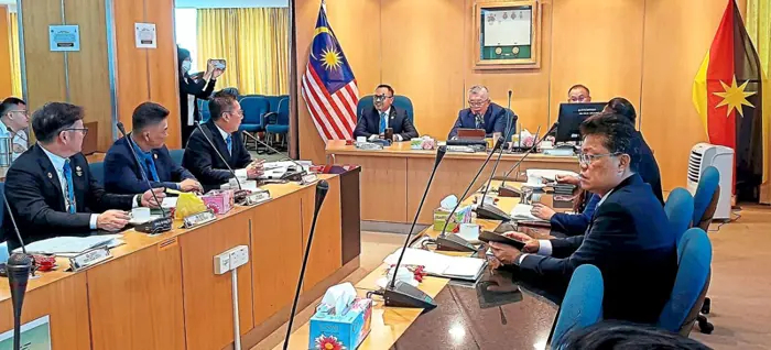 Ting (front table, centre) seen here chairing the meeting, says domestic waste arriving in plastic bags make proper compaction difficult.