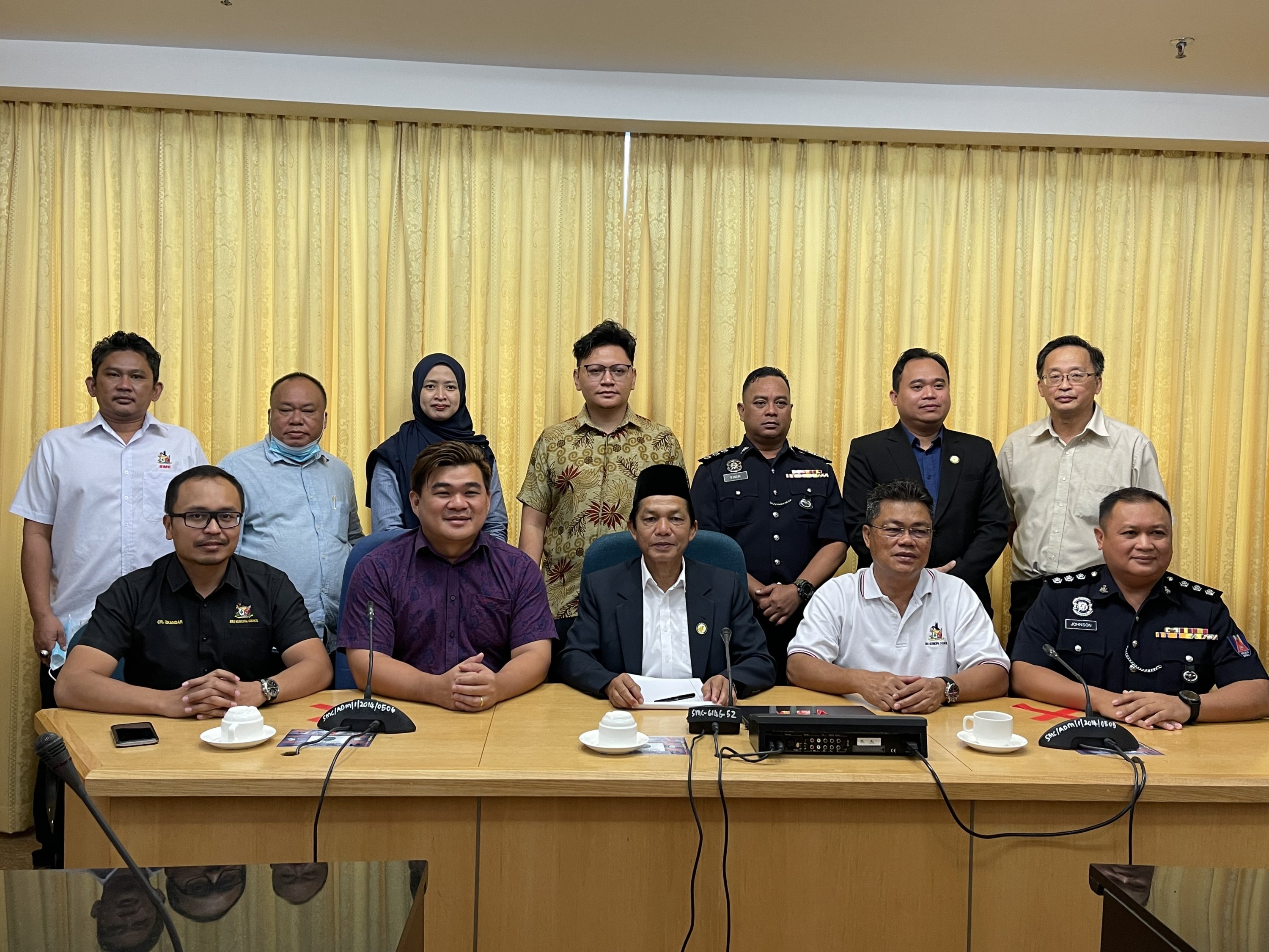 Bujang (seated centre) is seen in a group photo after the press conference. Seated from left are Izkandar, Ling, and Augustine.