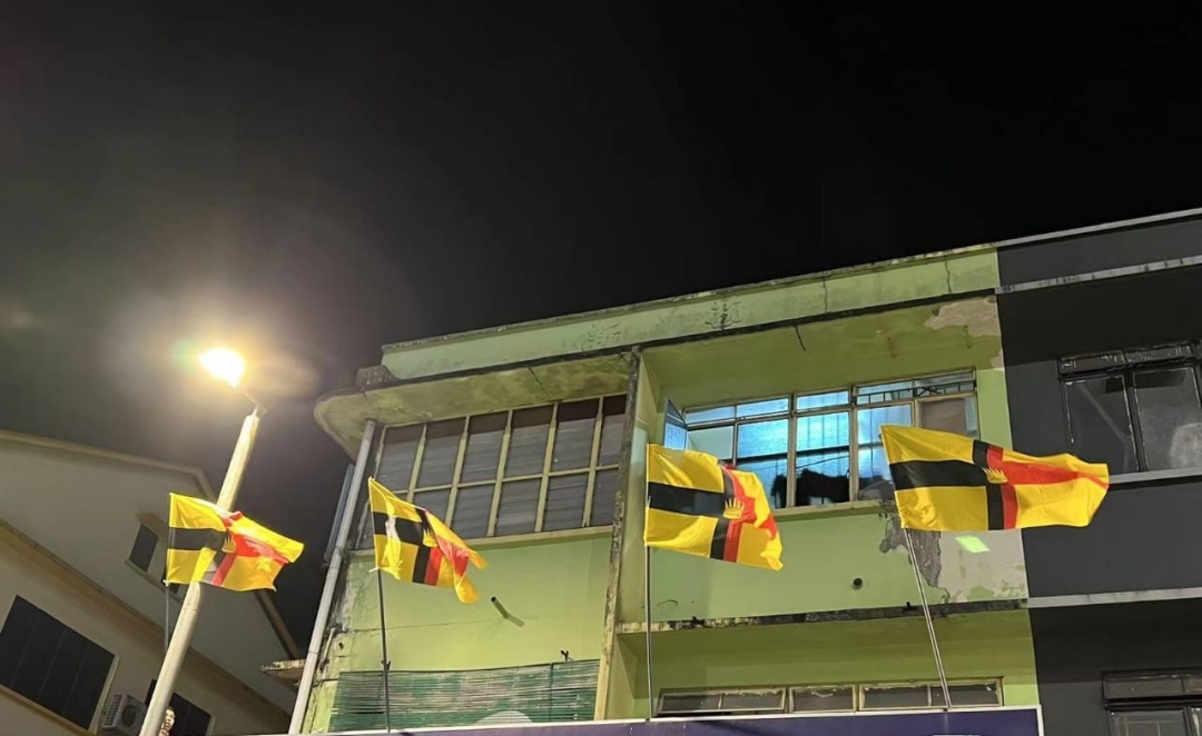 The crown flags flown on a building.