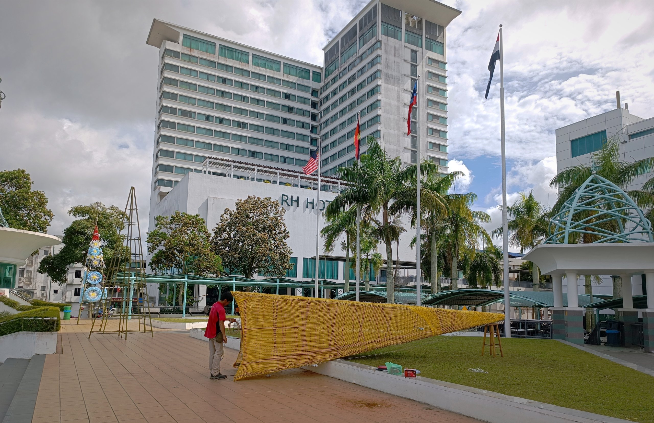 A worker/helper from one of the participating institutions working on one of the Christmas trees being erected at Dataran Tun Tuanku Bujang Phase 1. – Photo by Peter Boon