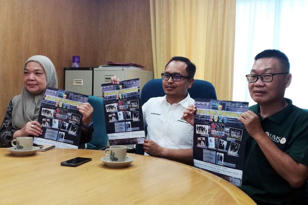 (From left) Zaiton, Mohammed and Yii holding the posters of the event.