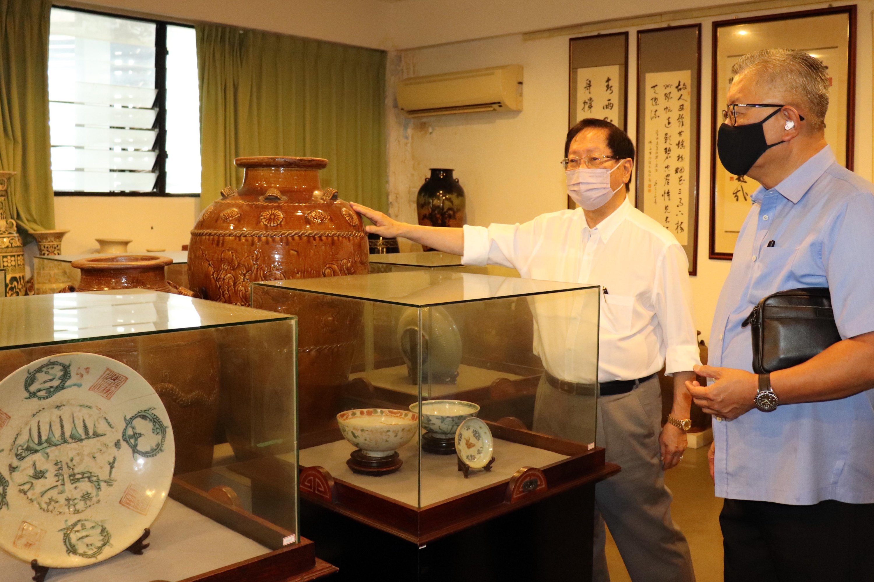 Lau (second right) and Ting view some of the artifacts on display at the museum. – Photo by Conny Banji