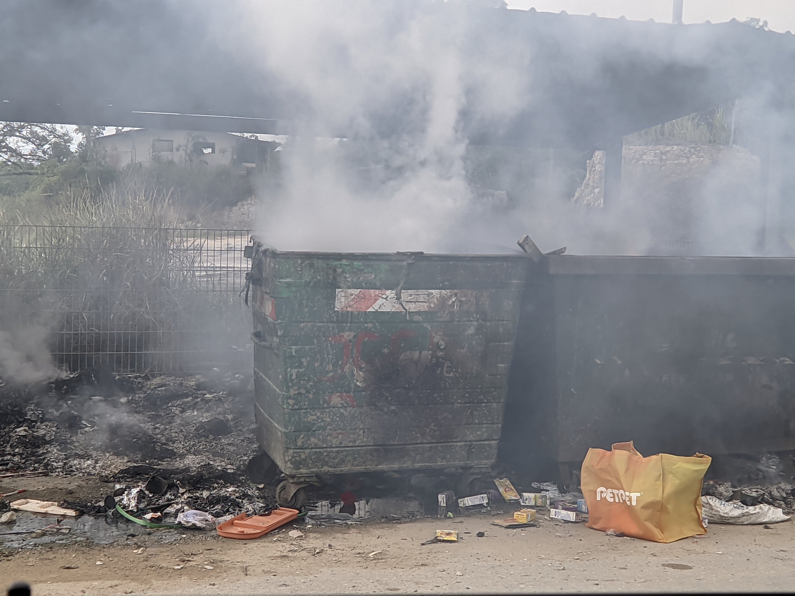 The bins at a rubbish collection point that were set on fire at a residential area in Jalan Bukit Penyau, Salim on Sunday.