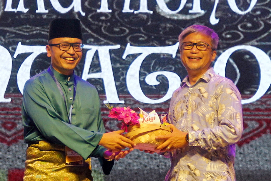 Izkandar (left) presents a memento to Dr Annuar.