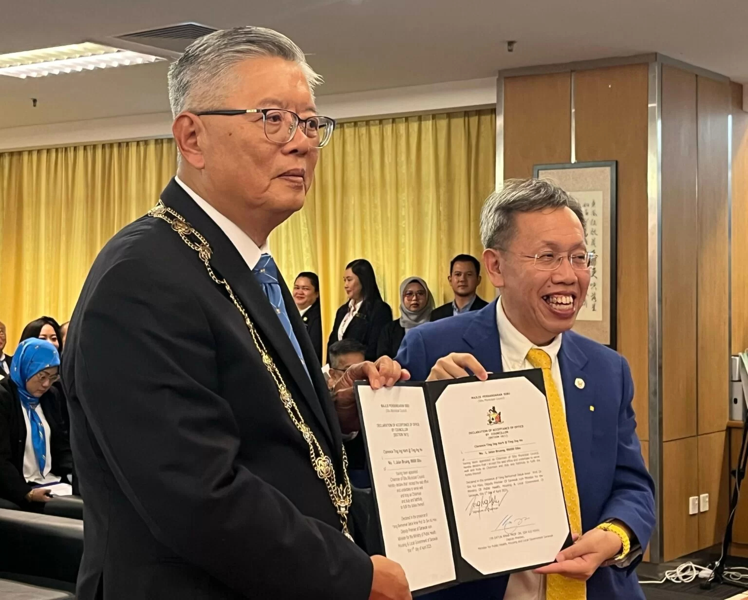 Ting (left) received his appointment letter from Dr Sim.