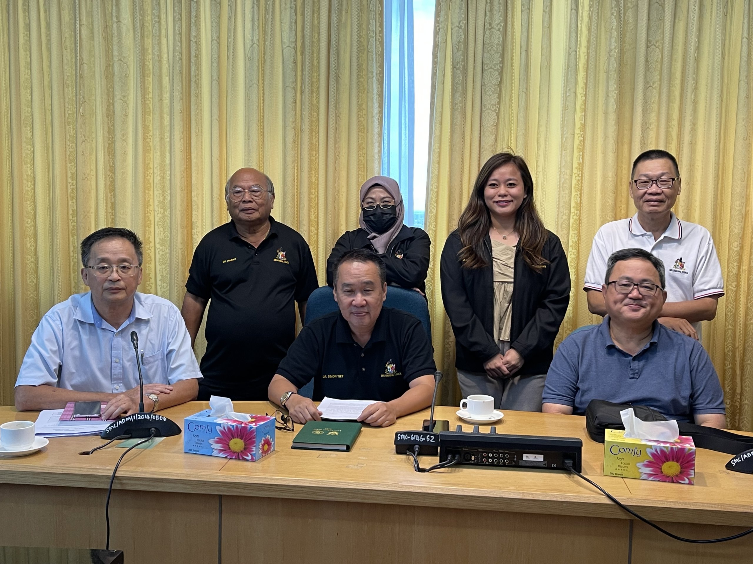 Wee (seated, centre) and others in a group photo, taken after the press conference.