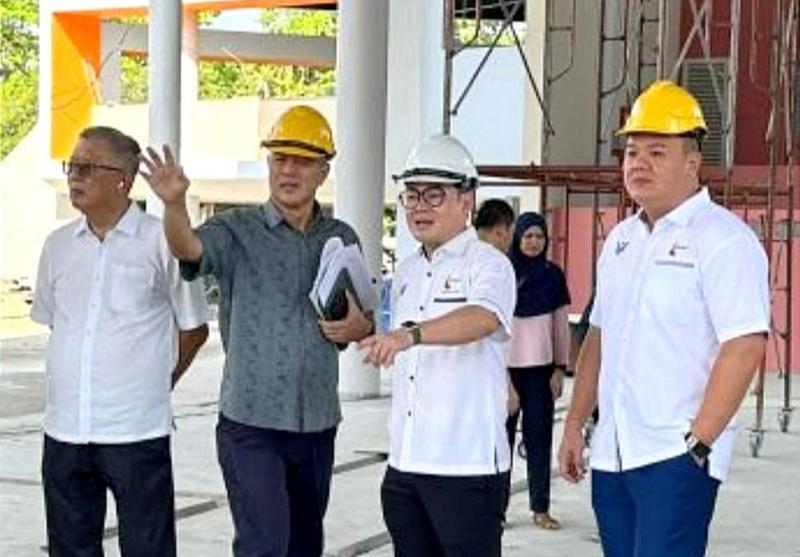 Tiang (second from right) being briefed on the progress of the project.