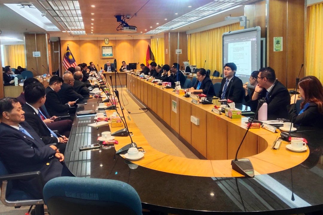Photo shows the meeting in session yesterday.