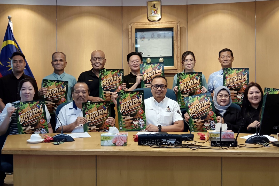 Izkandar (seated centre) and BCF 2025 organising committee members showing the event’s promotional posters.