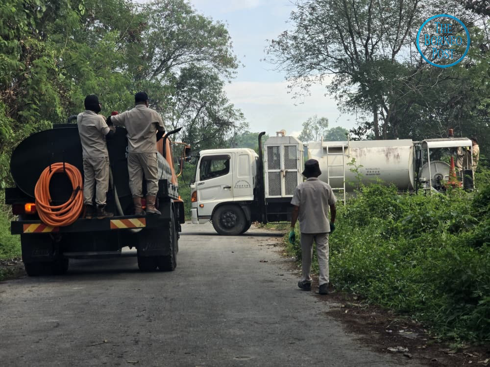 SMC’s water trucks arrive at the closed Seng Ling dumpsite. – Photo by Peter Boon