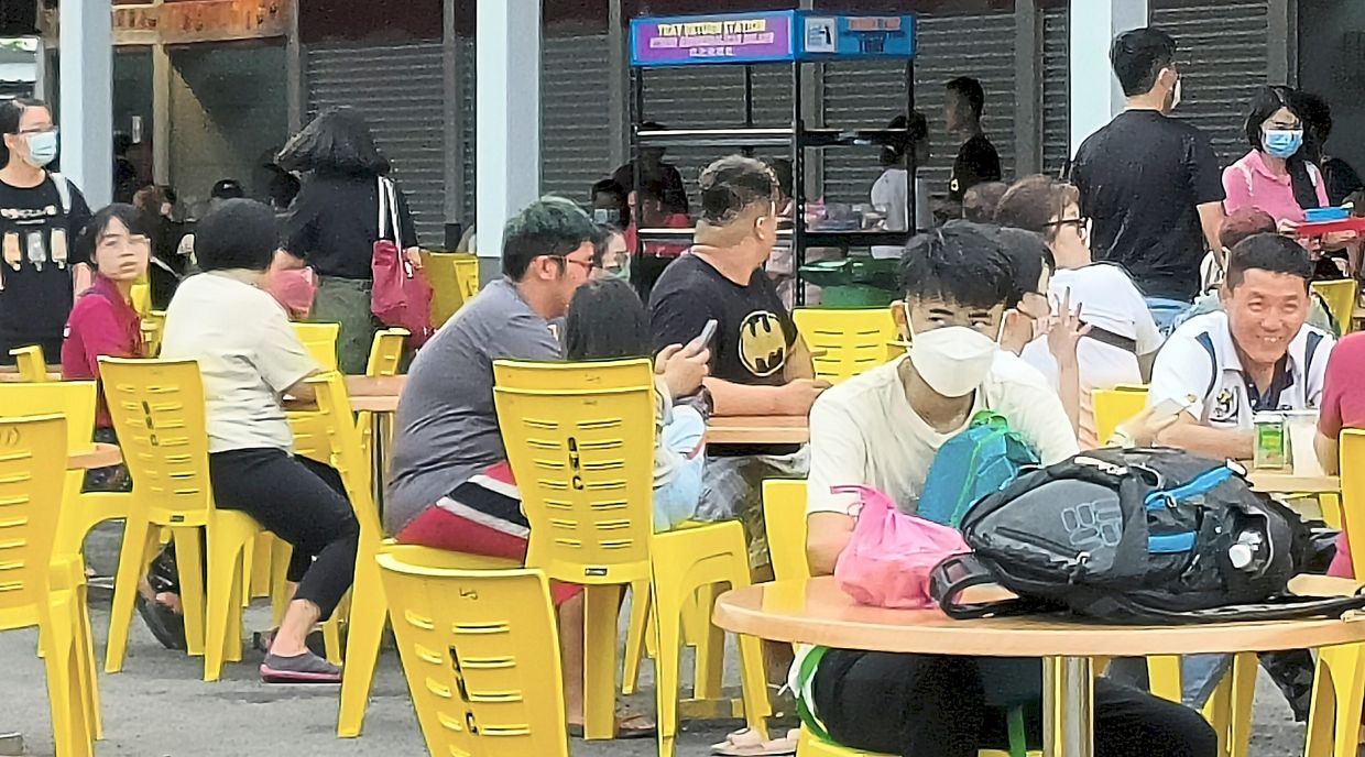 Locals enjoying the food at the newly upgraded Taman Selera Muhibbah food court on its first day of opening.