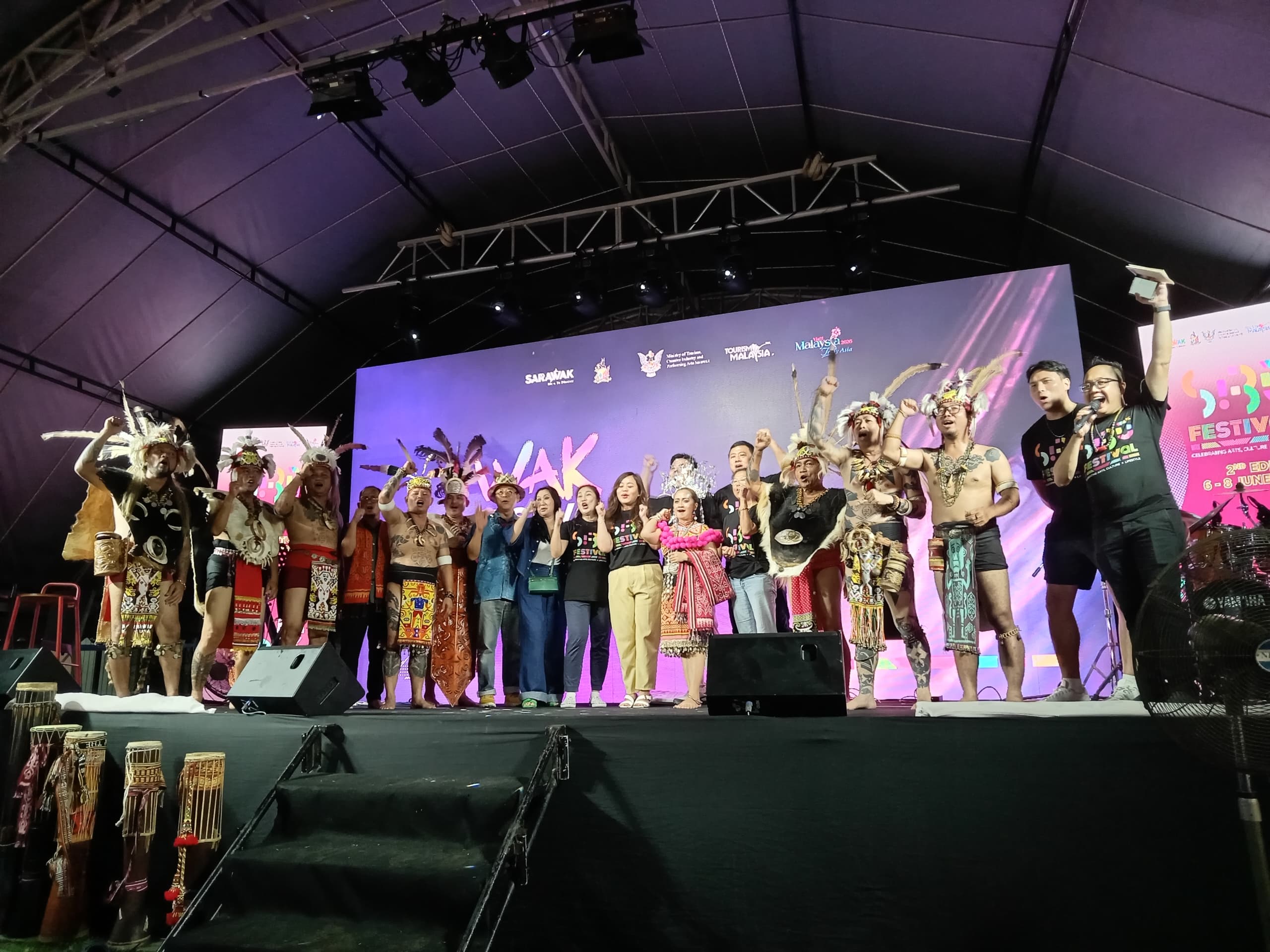 Law (11th left) poses for a group photo with some of the performers.